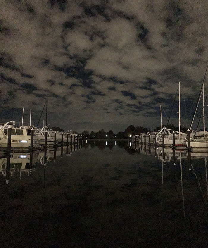 Noisy (Grainy) Picture of Nightime Clouds Reflected in Yacht Marine Fairway.